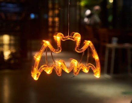 Bat-shaped LED light decoration on a blurred background