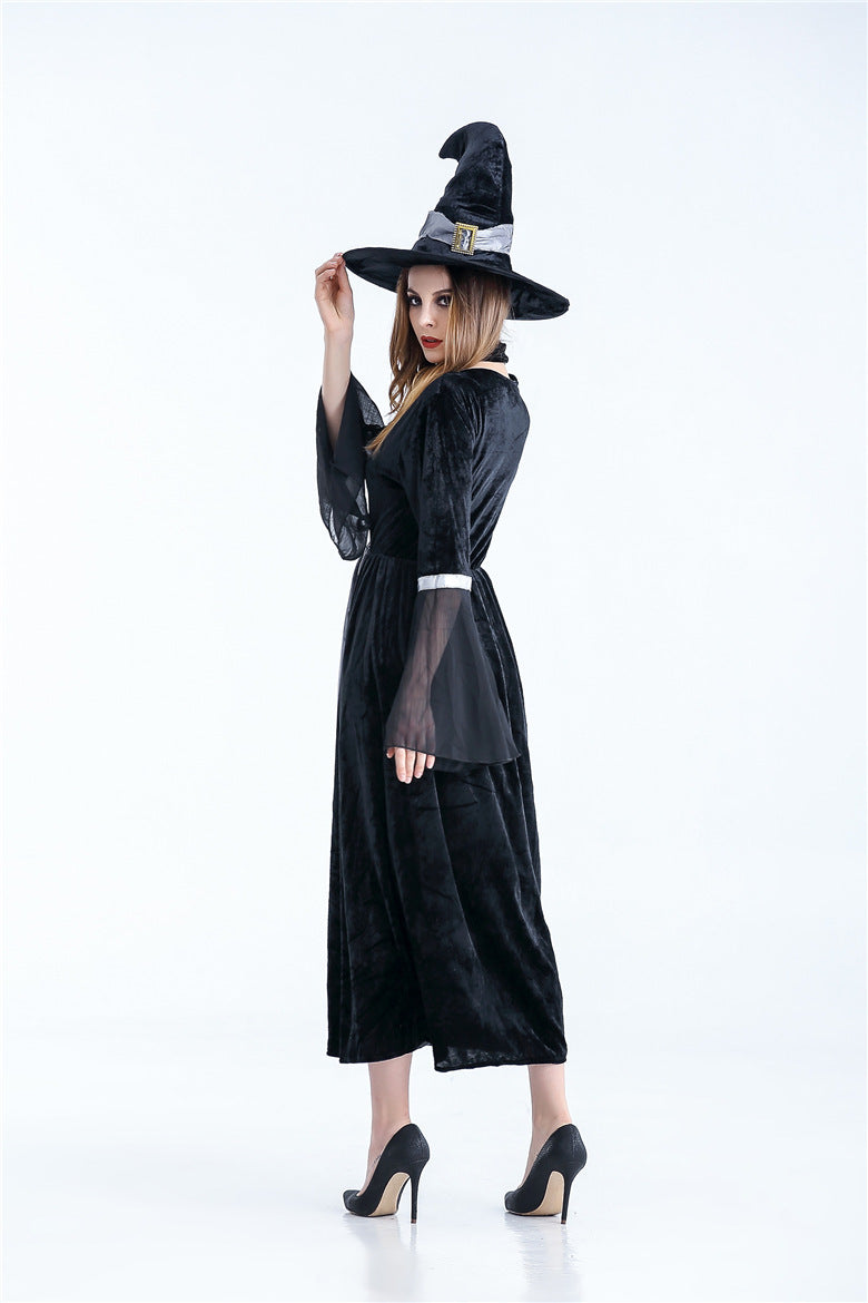 Person wearing a black witch costume with a hat on a white background
