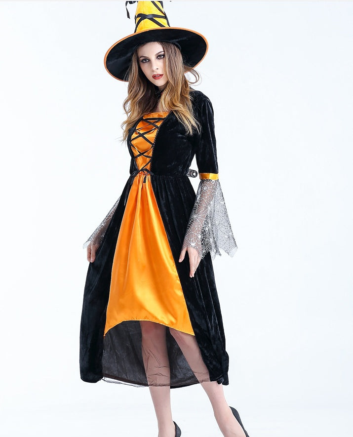 Woman wearing a black and orange Halloween costume with a witch hat on a white background