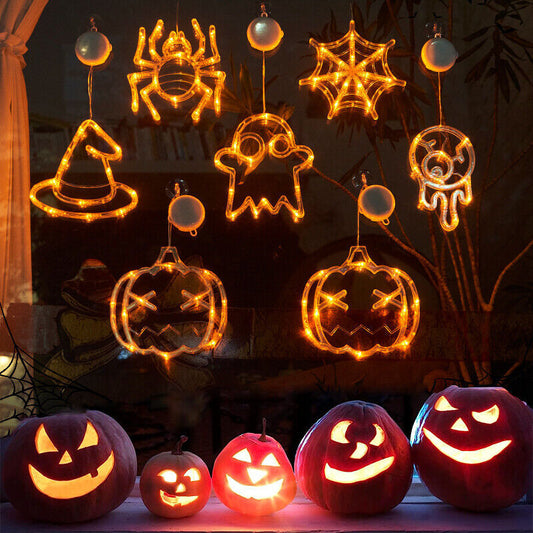 Halloween-themed string lights shaped like pumpkins, ghosts, and spiders on a dark background.