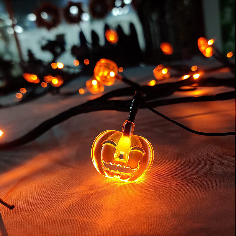 String of Halloween lights with jack-o'-lantern design on a dark background