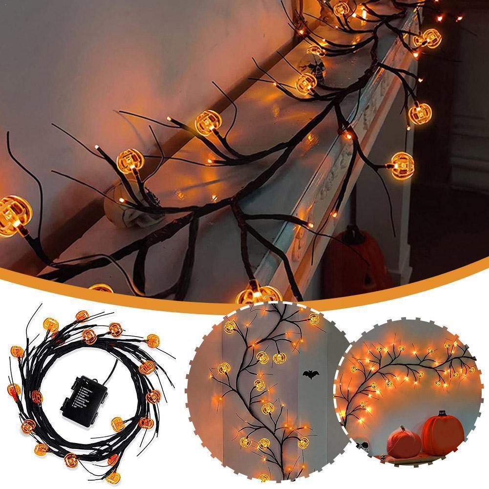 Halloween-themed string lights with pumpkins and a bat on a dark background
