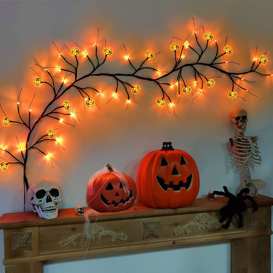 Halloween-themed decoration with pumpkins, skulls, and skeleton on a mantelpiece.