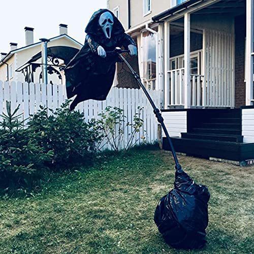Halloween decoration of a ghostly figure with a bag in front of a house.
