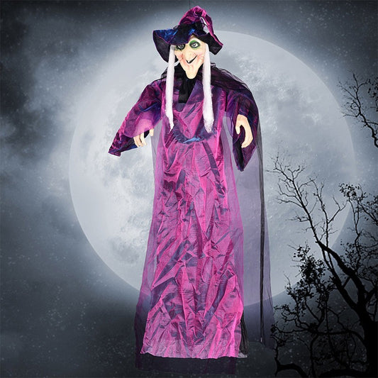 Halloween decoration of a witch in a purple outfit against a moonlit sky.