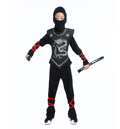 Child wearing a black ninja costume with dragon design, holding a black foam sword on a white background.