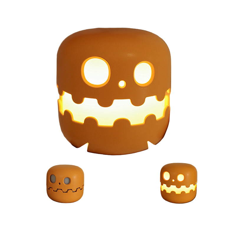Halloween-themed night light with a glowing face, held by a person.