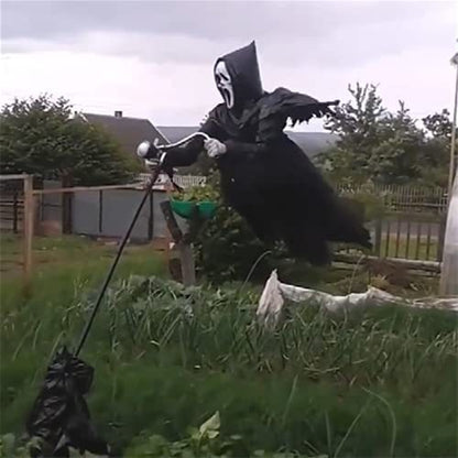 Scary Halloween decoration resembling a ghost with a broom in a backyard.
