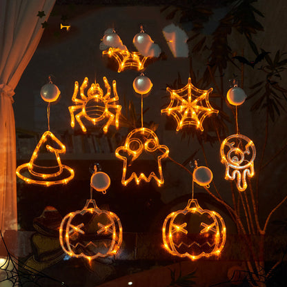 Halloween-themed string lights shaped like ghosts, pumpkins, and spiders on a dark background.